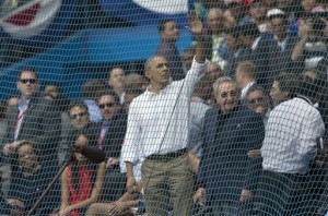 Cuban President Raul Castro, center right, and U.S. President Barack Obama, waving, attend a baseball game between the Tampa Bay Rays and Cuba's national team in Havana, Cuba, Tuesday, March 22, 2016. The crowd roared as the leaders entered the stadium and walked toward their seats in the VIP section behind home plate. It's the first game featuring an MLB team in Cuba since the Baltimore Orioles played in the country in 1999. (Ismael Francisco/Cubadebate via AP)